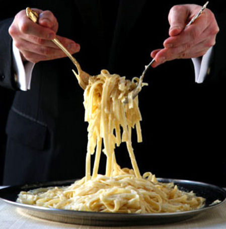 Waiter serving Fettucinni Alfredo